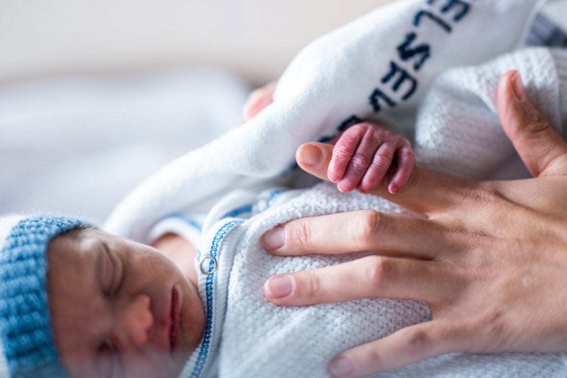 En baby som holdes av en person