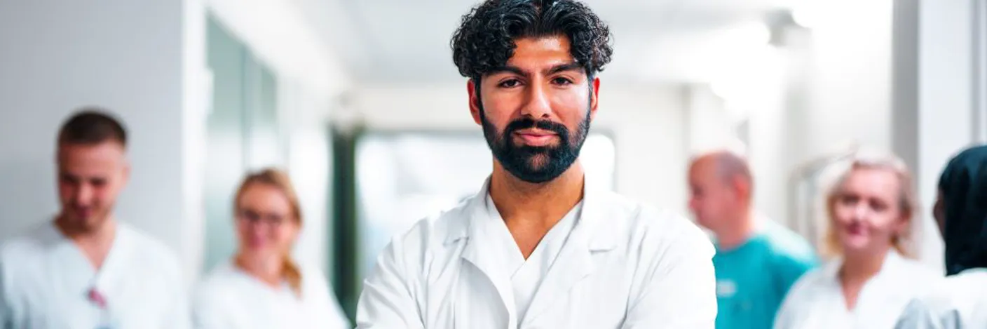 A man with a beard and a white lab coat