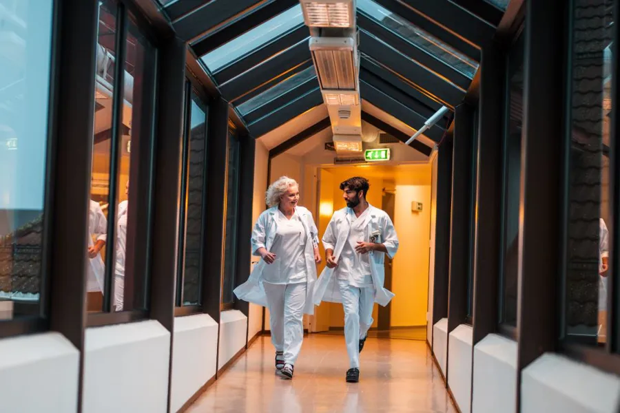 A couple of men walking down a hallway