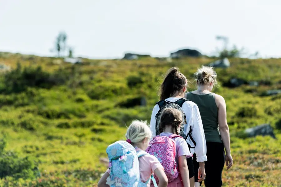 A group of people walking in a field