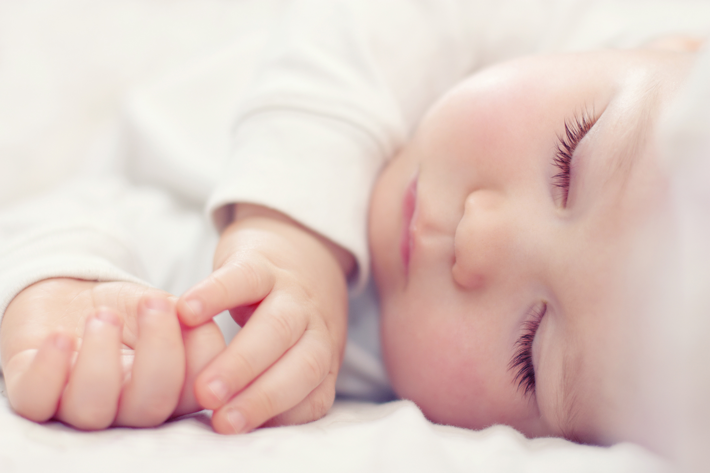 A baby sleeping with its eyes closed