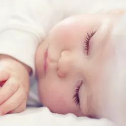 A baby sleeping with its eyes closed