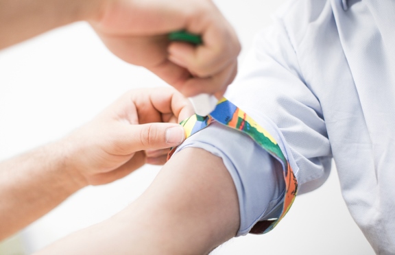 Pasient med bånd på overarmen, illustrasjonsfoto