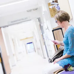 Pasient som venter i gangen på sykehuset, illustrasjonsbilde