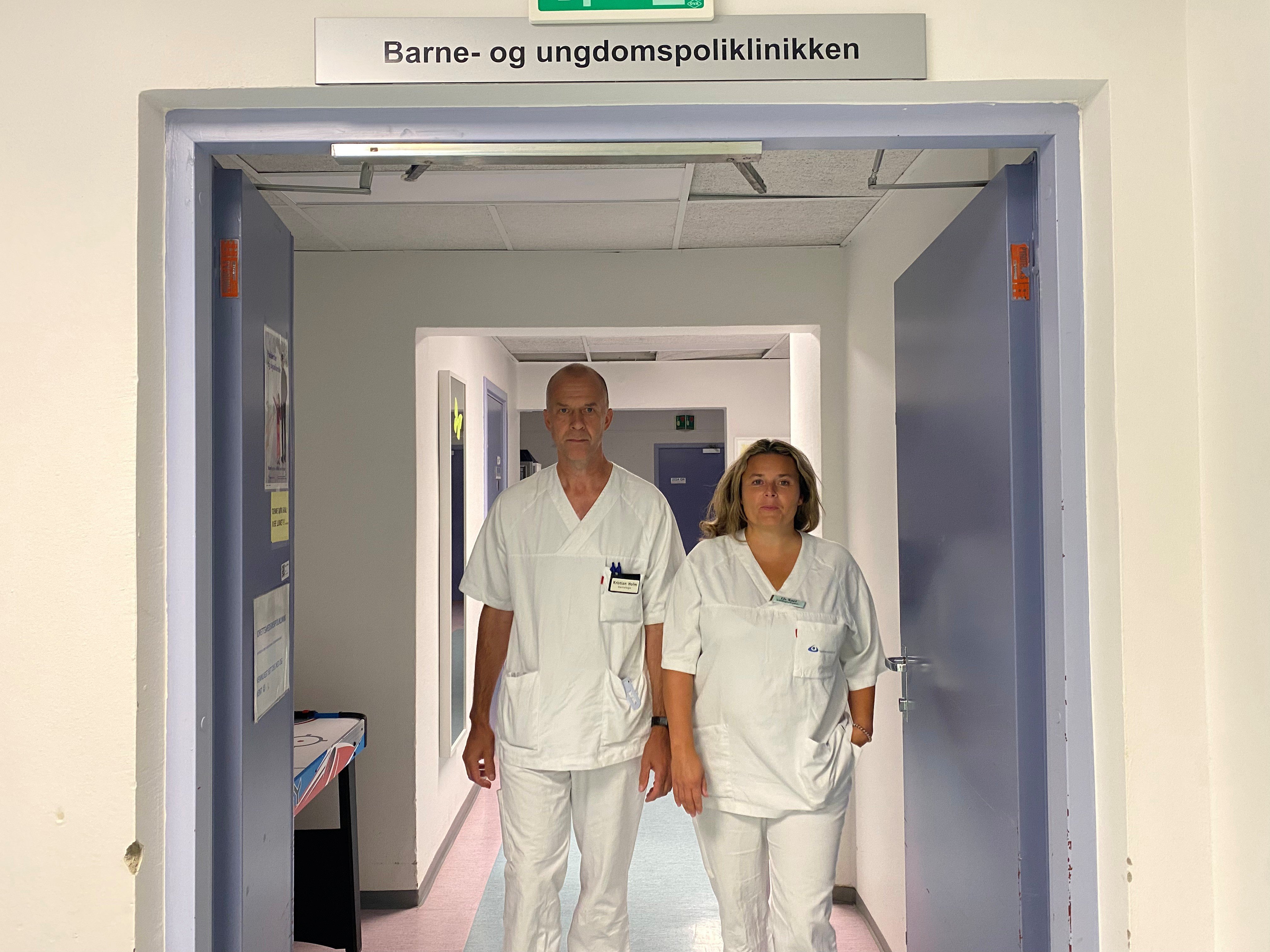 Lege og sykepleier i sykehuskorridor