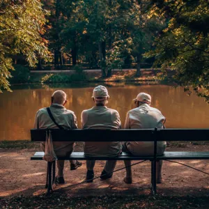 A group of old men sitting on a bench